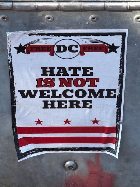 Poster affixed to lamp post that says "Free DC Free" and "Hateiis not welcome here."
