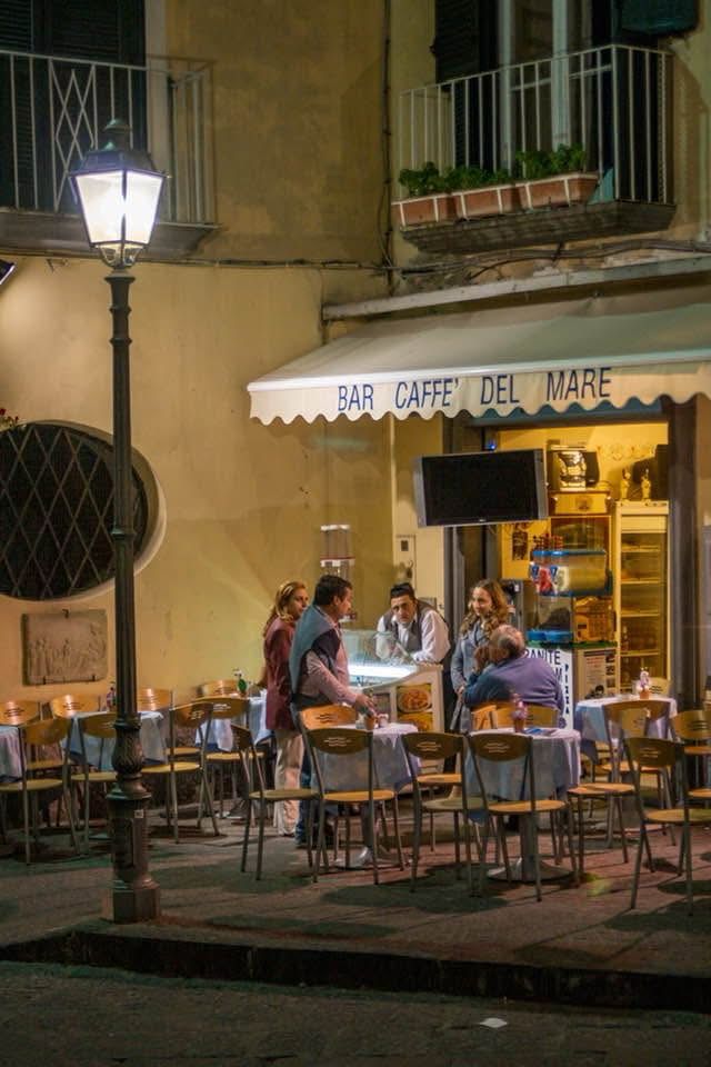 I’ve been going through old photos from the three weeks I spent studying photography in Italy in 2007. After recently reading Anthony Doerr’s “Four Seasons in Rome,” I started thinking about my own trip (only a couple of years after Doerr’s 2005-06 trip) and struck me how quickly I fell into a routine, heading most mornings to a little sidewalk cafe not far from my apartment in the seaside town of Sorrento. The cafe sat tucked in the corner along a curve of a narrow street, perfect for sitting with a cappuccino and a croissant and watching people going by. All these years later, a Facebook friend seeing my photograph I posted of the cafe interpreted the name of it, something I never bothered to do. Caffe’ Del Mar means Cafe by the Sea. How beautiful. How perfect. 
