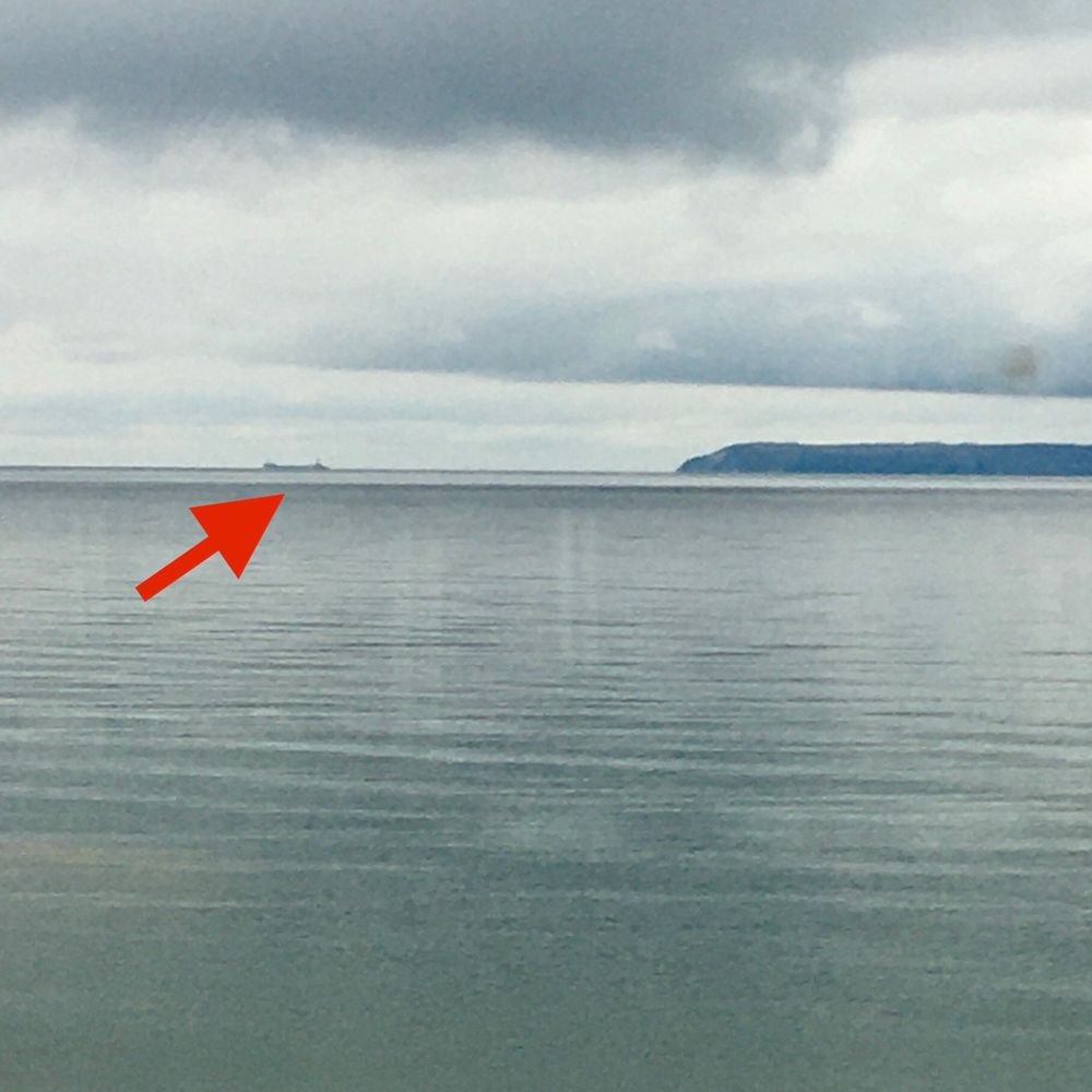 A rainy day on Lake Michigan with a freighter approaching South Manitou Island