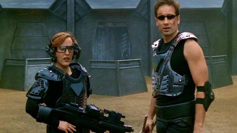 Scully and Mulder decked out in video game body armor in the X-Files episode “First Person Shooter.”