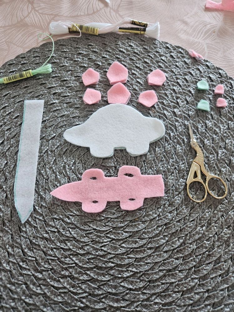 Process of making the stegosaurus. 
Plates are sorted into one group and body and belly is placed next to each other.