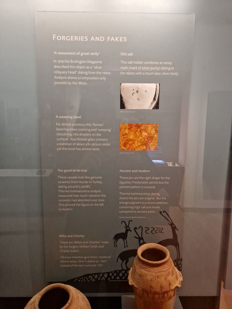 A museum panel explaining how scientific research can determine whether objects are fake or forgeries