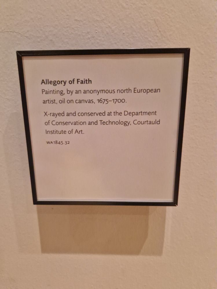An object label in a museum describing a painting called 'Allegory of Faith'