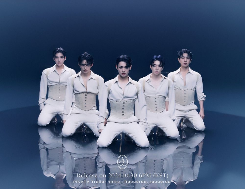 kpop group A.C.E. all members are kneeling,  wearing white suits with corsets