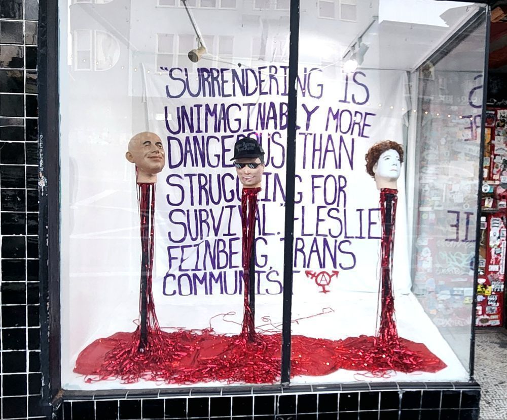 Gay Shame window display: "Surrendering is unimaginably more dangerous than struggling for survival." -Leslie Feinberg, trans communist