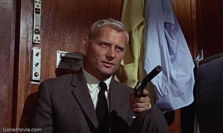 Robert Shaw as Red Grant holding gun in From Russia With Love train cabin. 