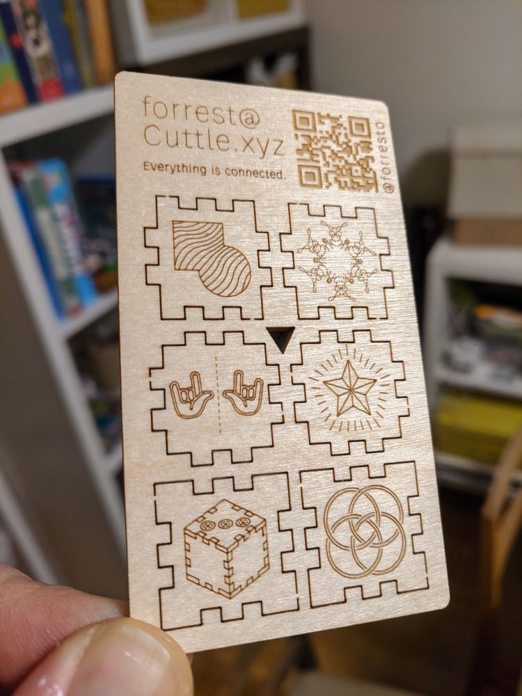 Flat-pack cube with sides representing Cuttle.xyz features like vector mask, isometric skew, over under weaving, rotational repeat, and emoji. forrest@cuttle.xyz and cuttle.xyz/@forresto