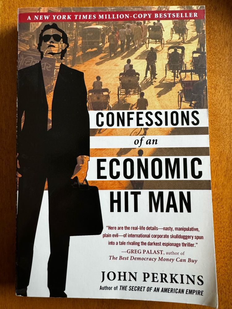 Book cover of Confessions of an Economic Hit Man by John Perkins, showing a man with a briefcase.