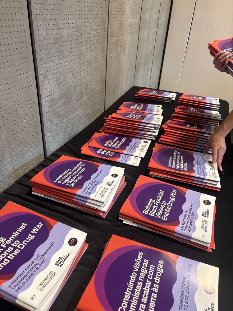 Picture of Building Black Feminist Visions to End the Drug War reports in English, Spanish & Portuguese laid out on a table. 