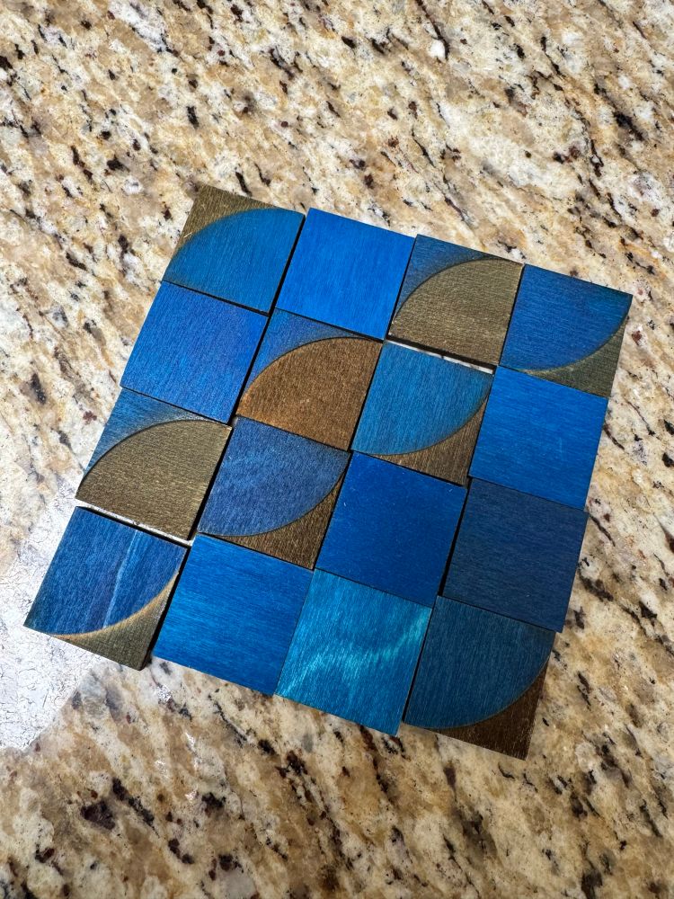Blue and black truchet tiles in a four by four pattern. 