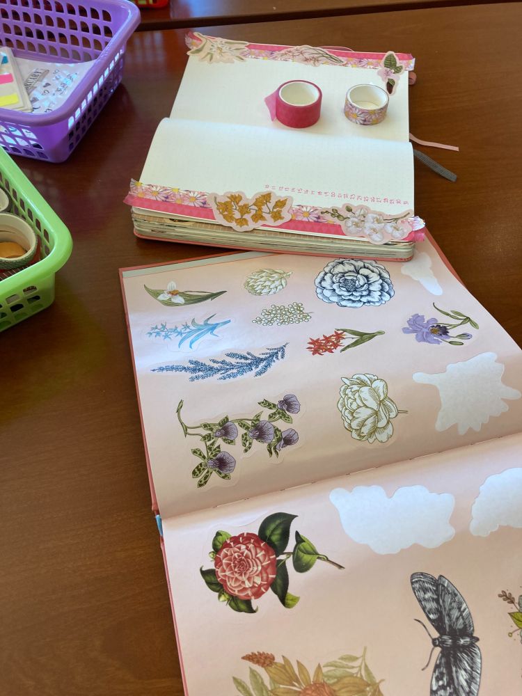 Photos of colorful bullet journaling supplies on a table in the library lounge.
