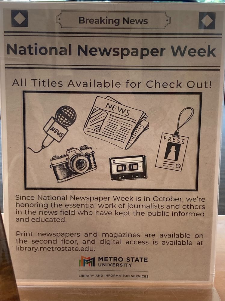 Photo of a library display that includes materials on journalism and news.