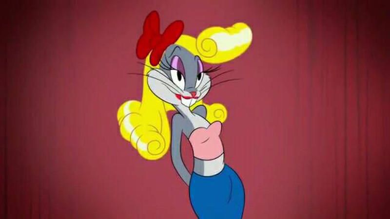 Animated image of Bugs Bunny in a blonde wig with a large red bow, a pink halter top and a blue 60’s skirt. 
