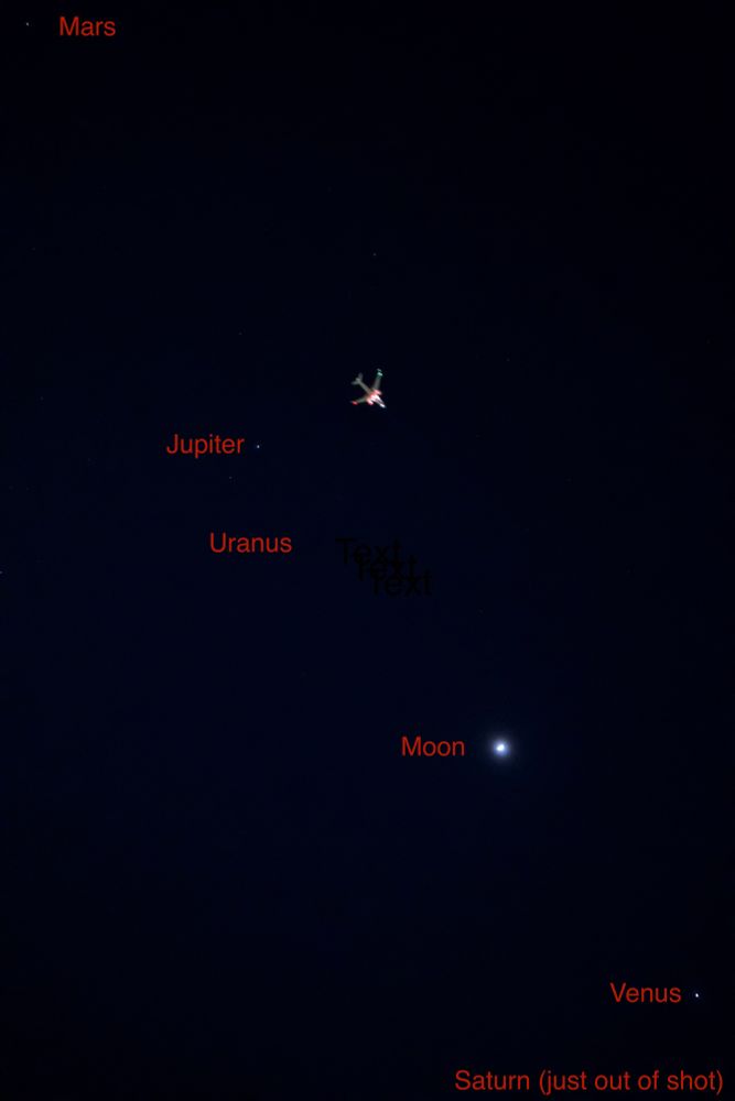 A one-up of planets visible in the night sky at the moment, with an airplane crossing the shot.