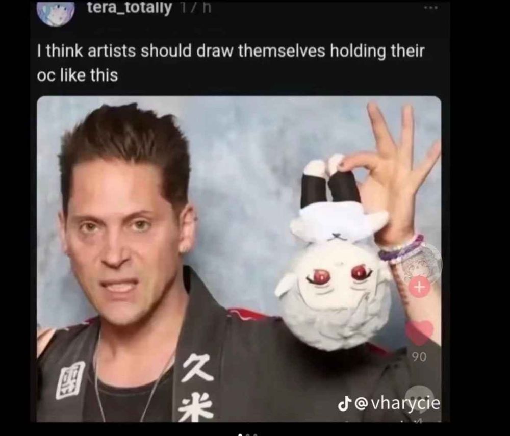 A person holding (what appears to be) an Asterion plushie upside down by the foot, with the caption "I think artists should draw themselves holding their OC like this"