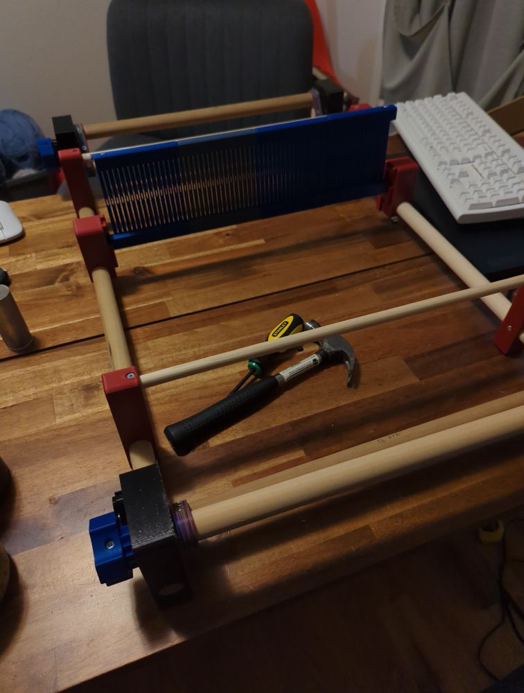 A ridgid heddle loom made from wooden dowels and 3d printed parts.