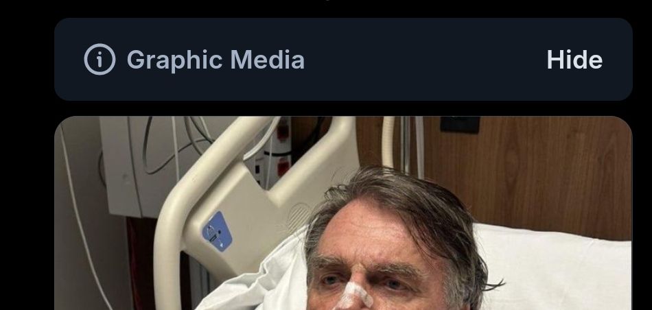 label de graphic media do bluesky, seguido de uma foto cortada de bolsonaro mostrando apenas os olhos tristes do desgraçado deitado numa cama de hospital 