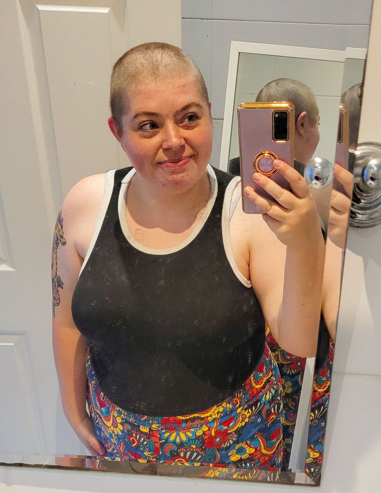 A selfie of Holly in her bathroom with a shaved head.
