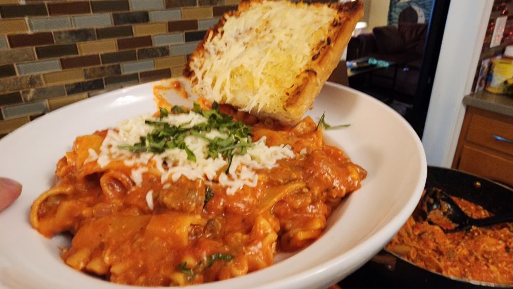 A plate of pasta and garlic bread