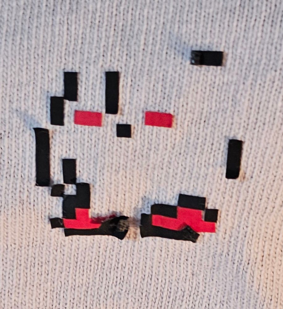 All these images are of a shirt that has sprites from Kirby's Adventure with various pixels either missing or out of place.