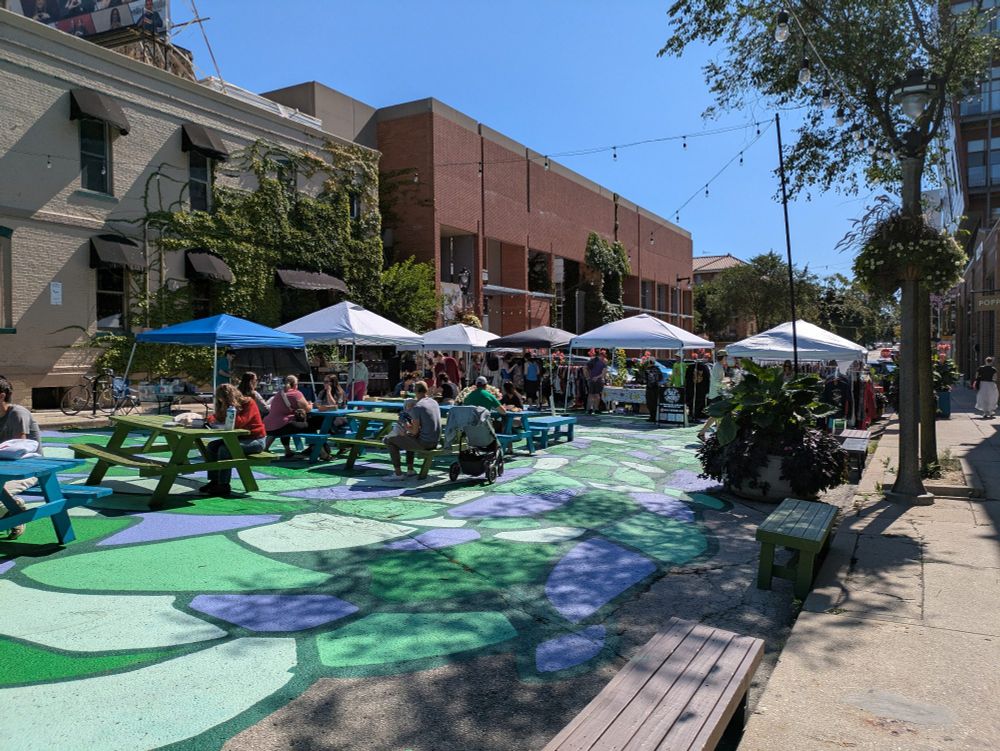 Ivanhoe Plaza filled with people and tents for local businesses