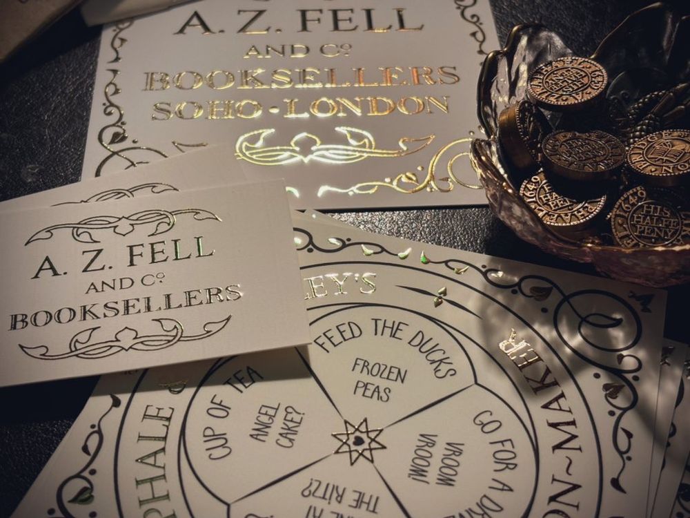 A selection of my ‘postcards’ and business cards embossed in gold, and a small dish of reproduction trade-tokens from my old shop on London Bridge.