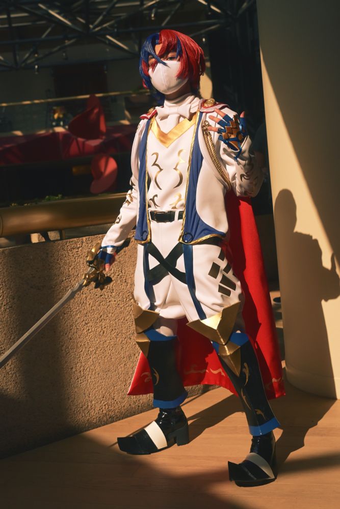 Full body photo of me cosplaying as Fire Emblem Engage main character Alear. Sword in right hand and Emblem ring adorned on left ring finger. Costume sewn by me! 