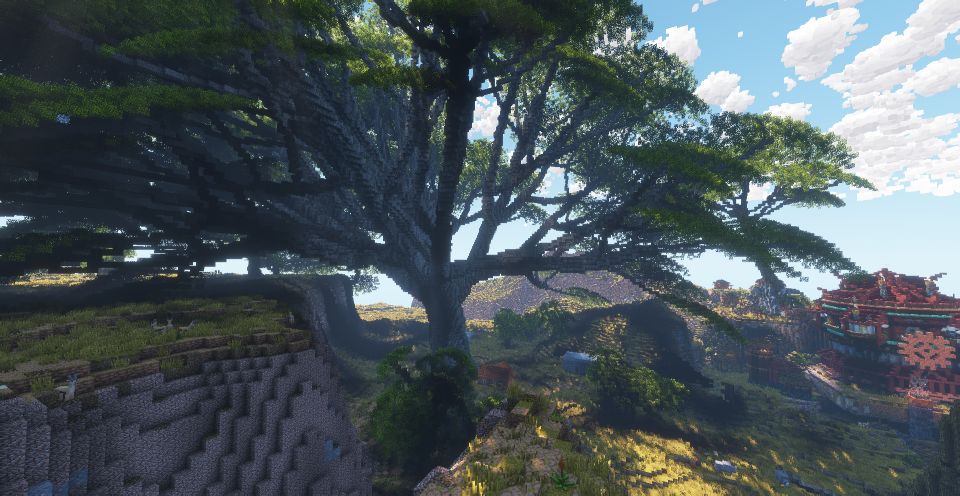 A Minecraft scene of a large tree shading a landscape and building to the right, the branches sag to touch the top of a rocky plateau.
