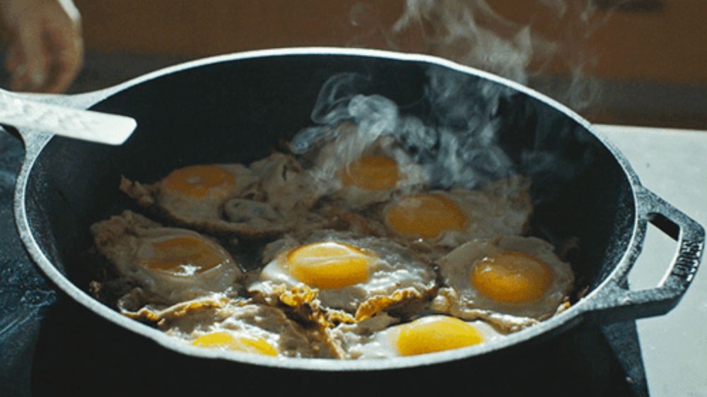 eggs are being cooked in a skillet that says lodge