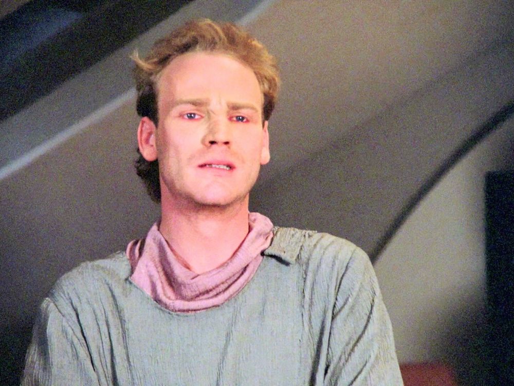 T'Jon, in guest quarters aboard the Enterprise as he speaks with Margan on the monitor 