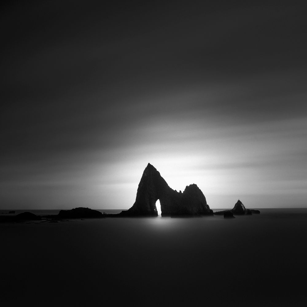 This is an image of a cathedral-like sea stack sitting in the waters of the Pacific Ocean off the West Coast of California.