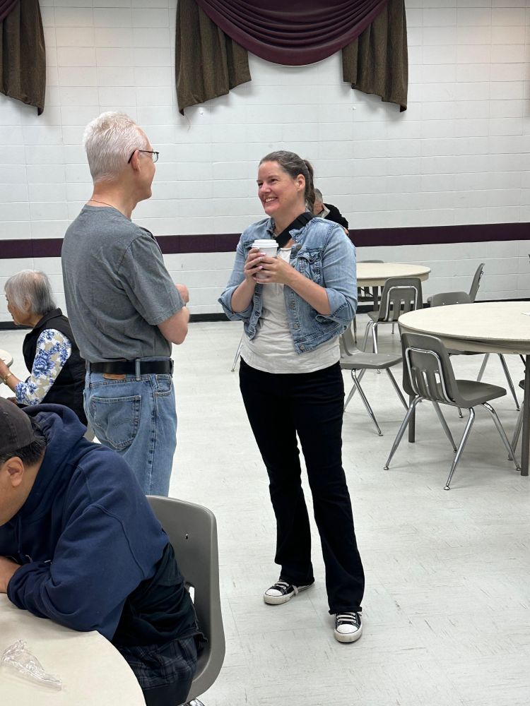 MLA Sweet speaking with someone at the event.