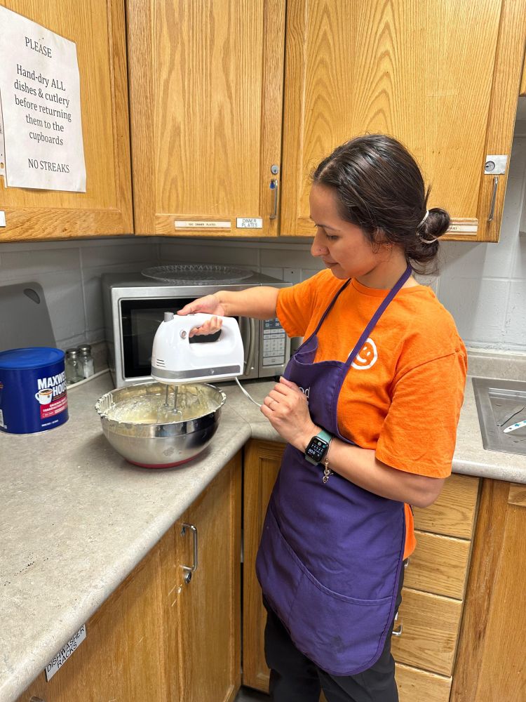Volunteer making the pancake batter.