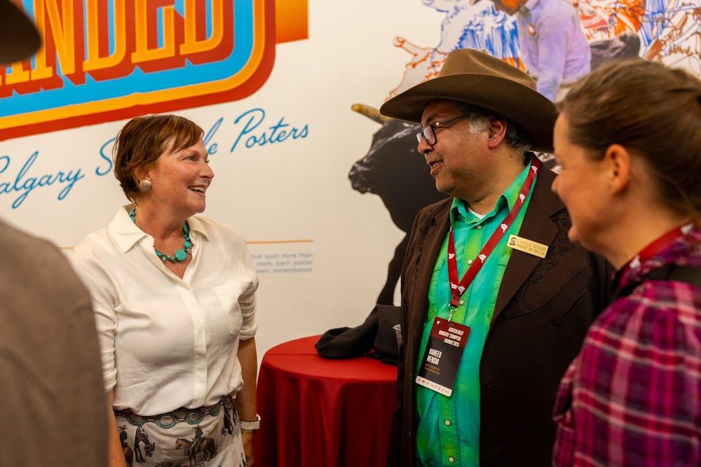 Image of MLA Sweet with Leader Nenshi talking to the recipient of the the 2025 Stewardship award