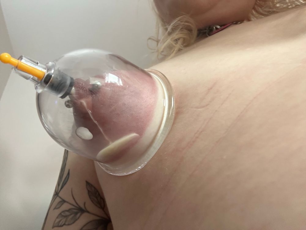 Kitty with a large nipple sucker connected to her boob pulling out milk from her pierced tits