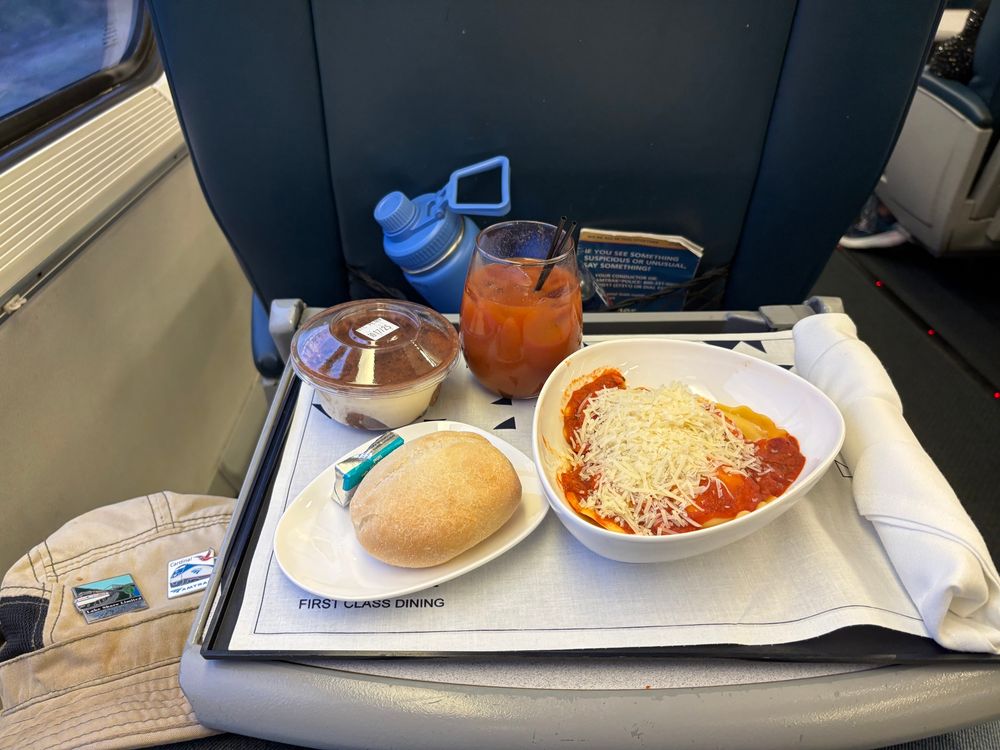 Ravioli, dinner roll, tiramisu and a Bloody Mary.