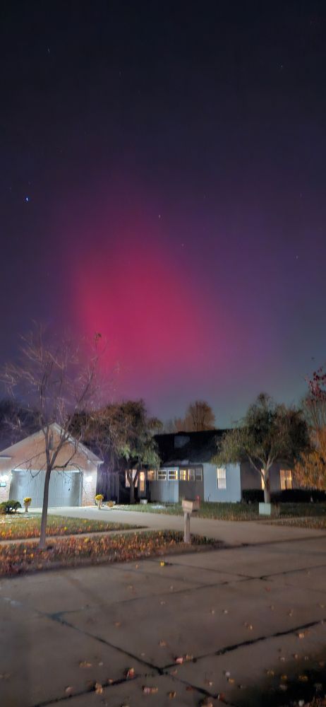 Pink Northern Lights over a Midwestern ranch style condo