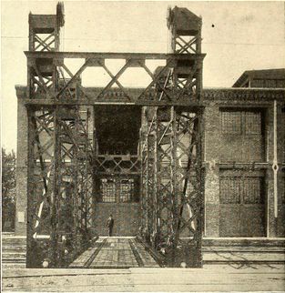 End-on view of a railroad transfer table with truss girder towers to raise the track between two levels