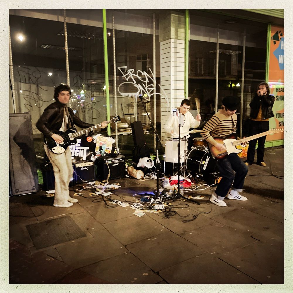 Young lads bass, guitar, drums, harmonica playing guerrilla gig on Stockwell Road, SW9