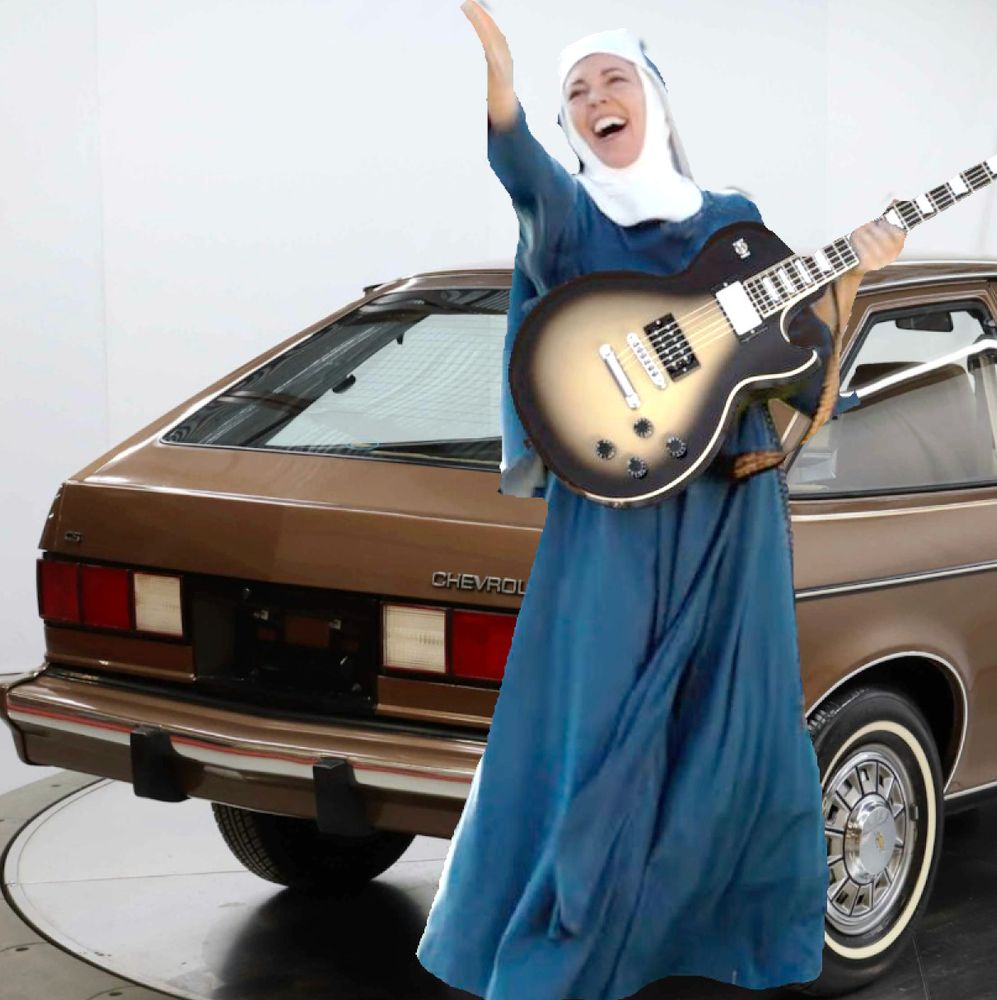 My nun with a guitar avatar standing in front of the rear fender of a brown Chevrolet Chevette 