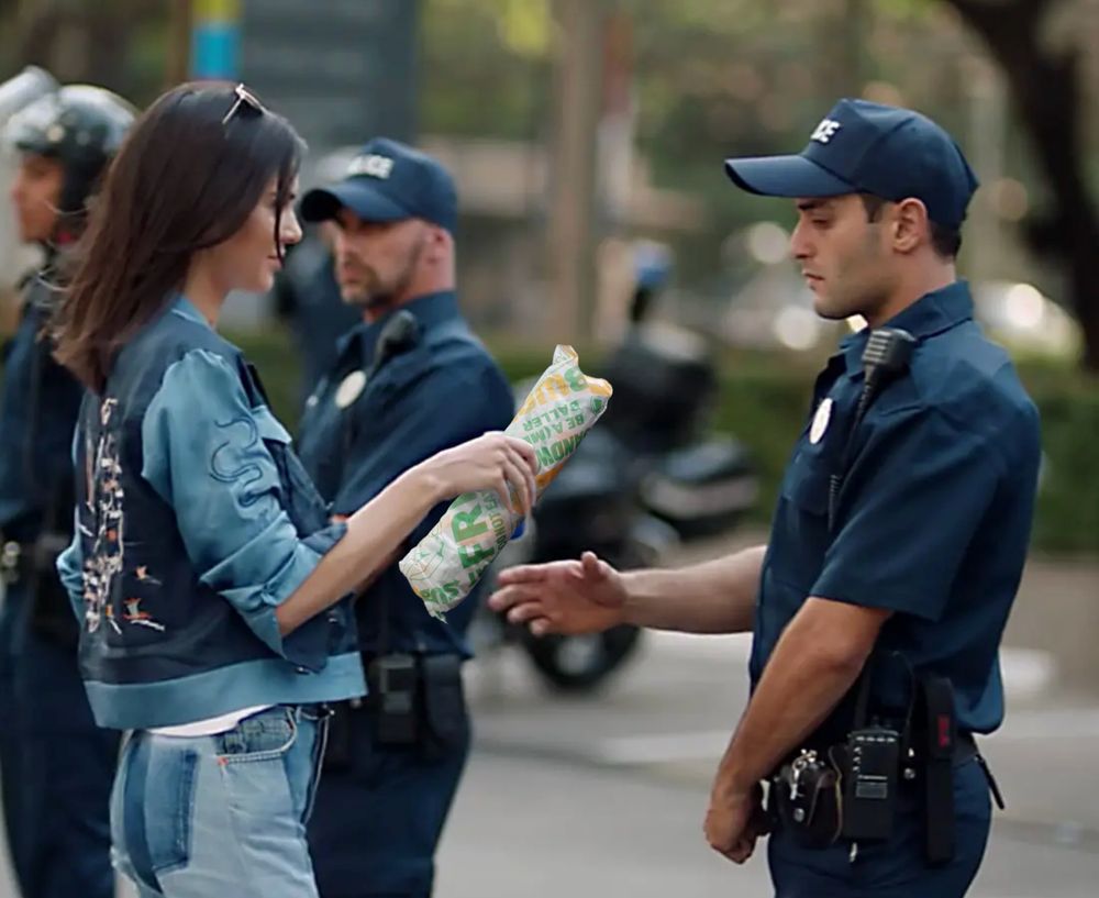 Kendall Jenner hands a footlong to a cop