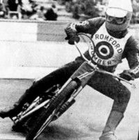 A black and white photo of Charlie Benham in action for the Romford Bombers speedway team