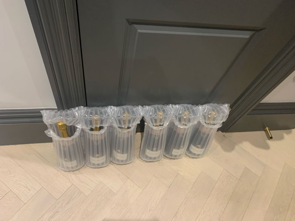 Six bottles of Bollinger in bubble wrap