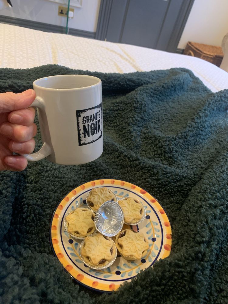 Picture of a plate of mince pies and a mug of tea