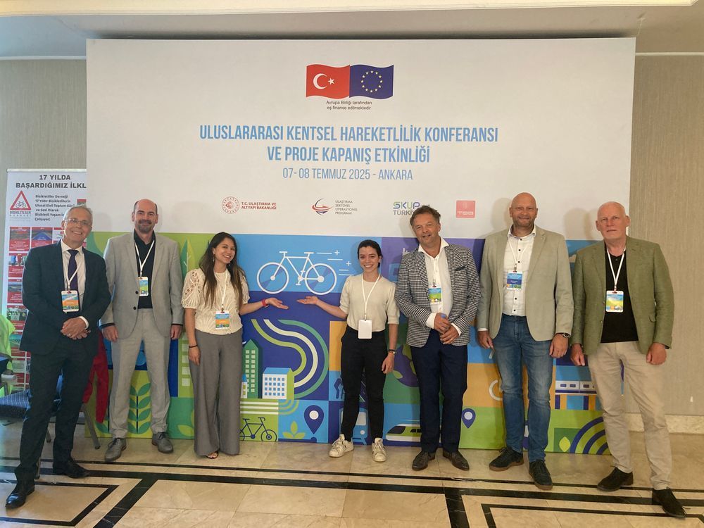 Members of the DCE network standing in front of banner