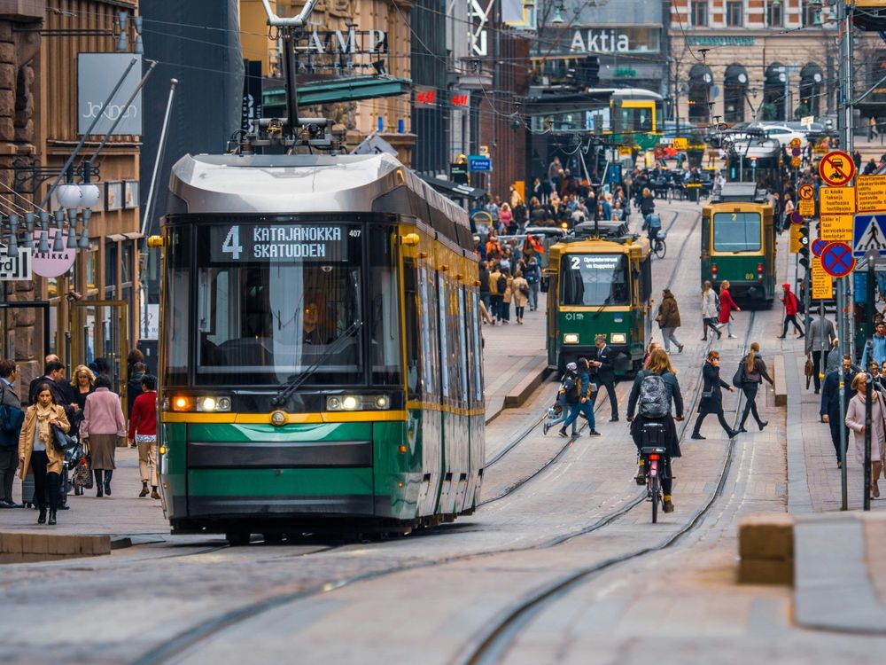 tram, cyclists, and pedestrians on busy Helsinki street