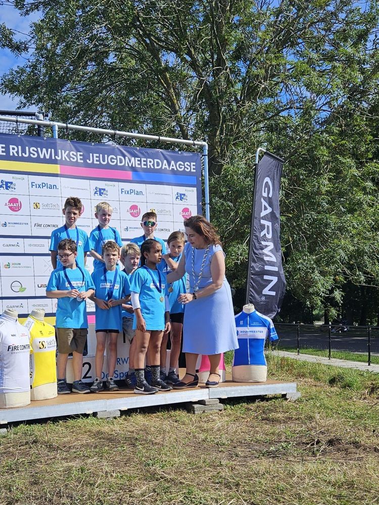 Kids standing on a podium wearing matching blue t-shirts