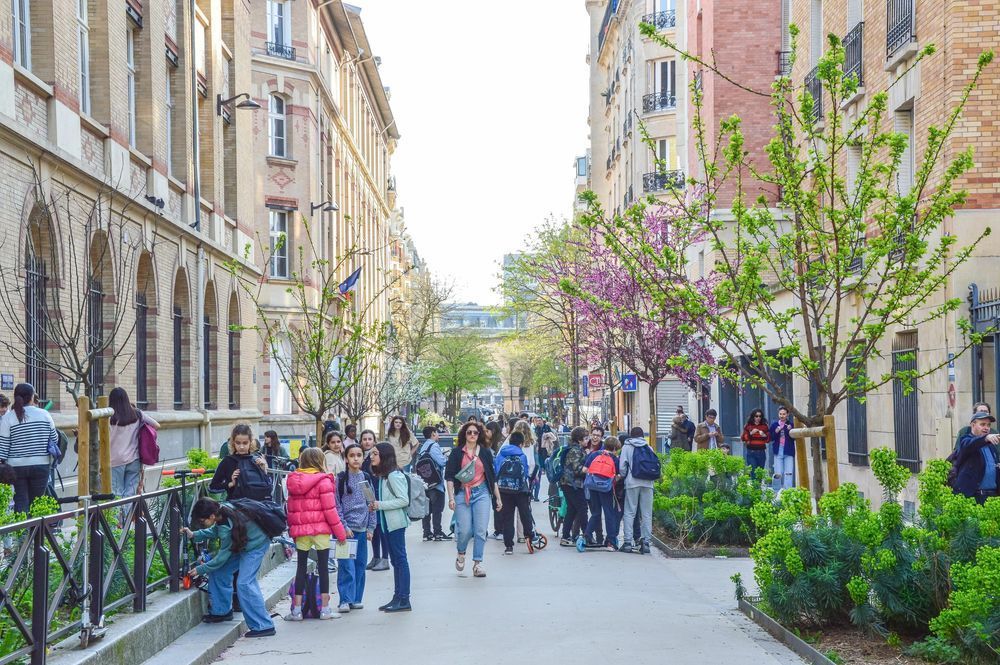 Car-free street full of children and other pedestrians