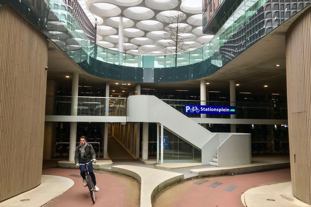 Cyclist exiting left side of high quality underground bike parking