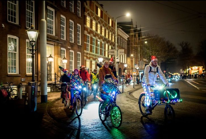 Cyclists at night with bikes lit up with twinkle lights